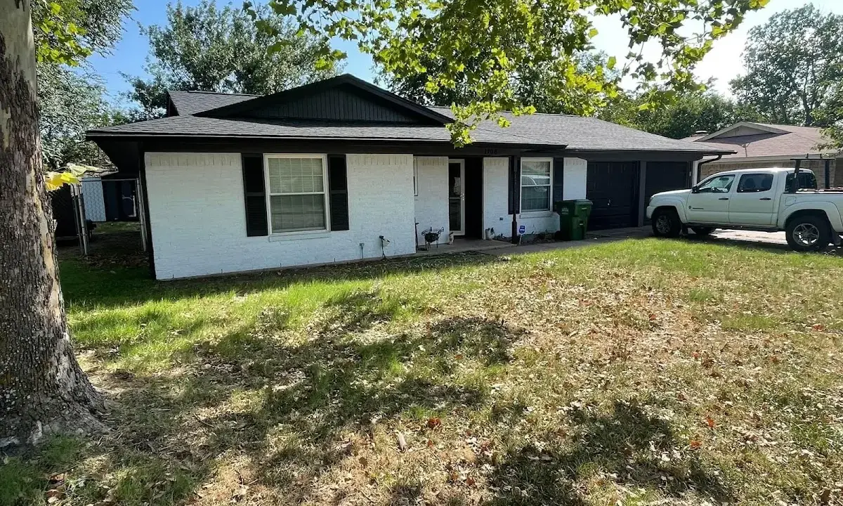 Professional roofing crew working on a residential roof in Mayfield